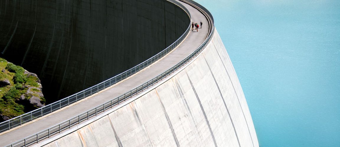 People walking along dam