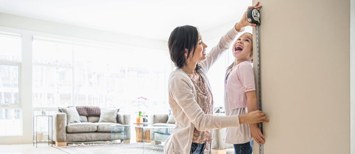 Mom measuring child's height