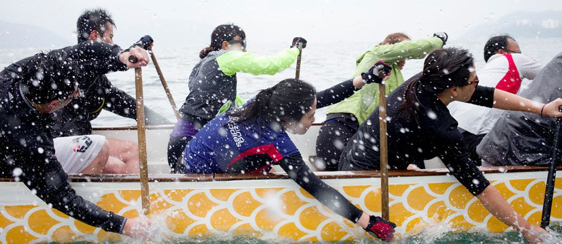 A team of rowers rowing a boat