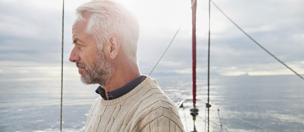 Man standing on boat looking out