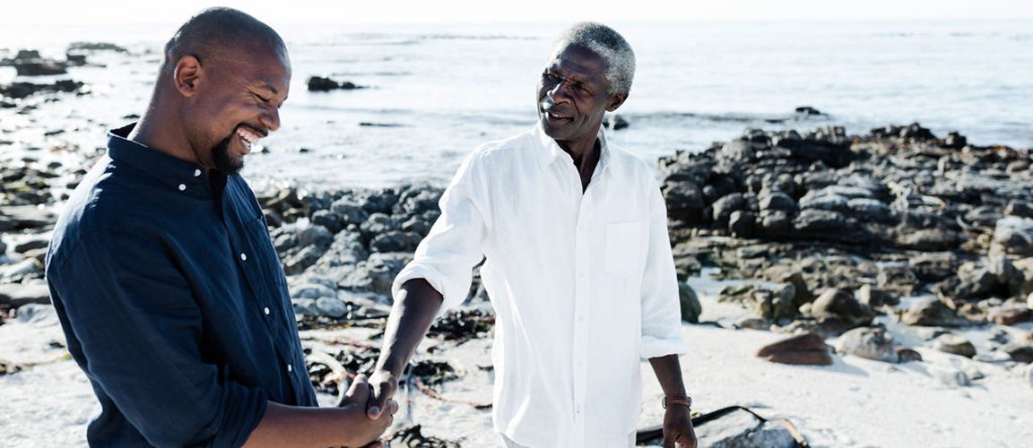 Father and son handshake on the beach