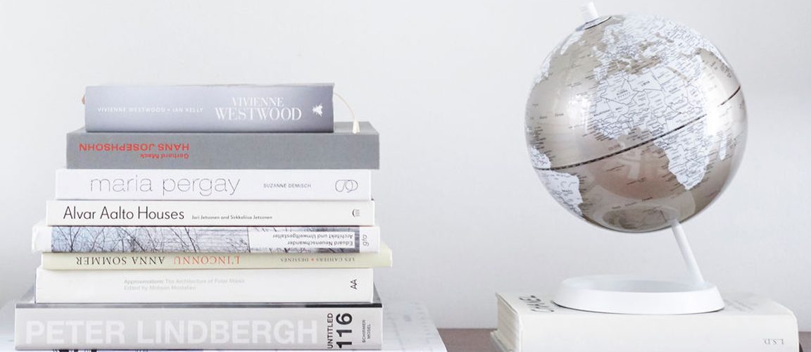 Globe next to stack of books